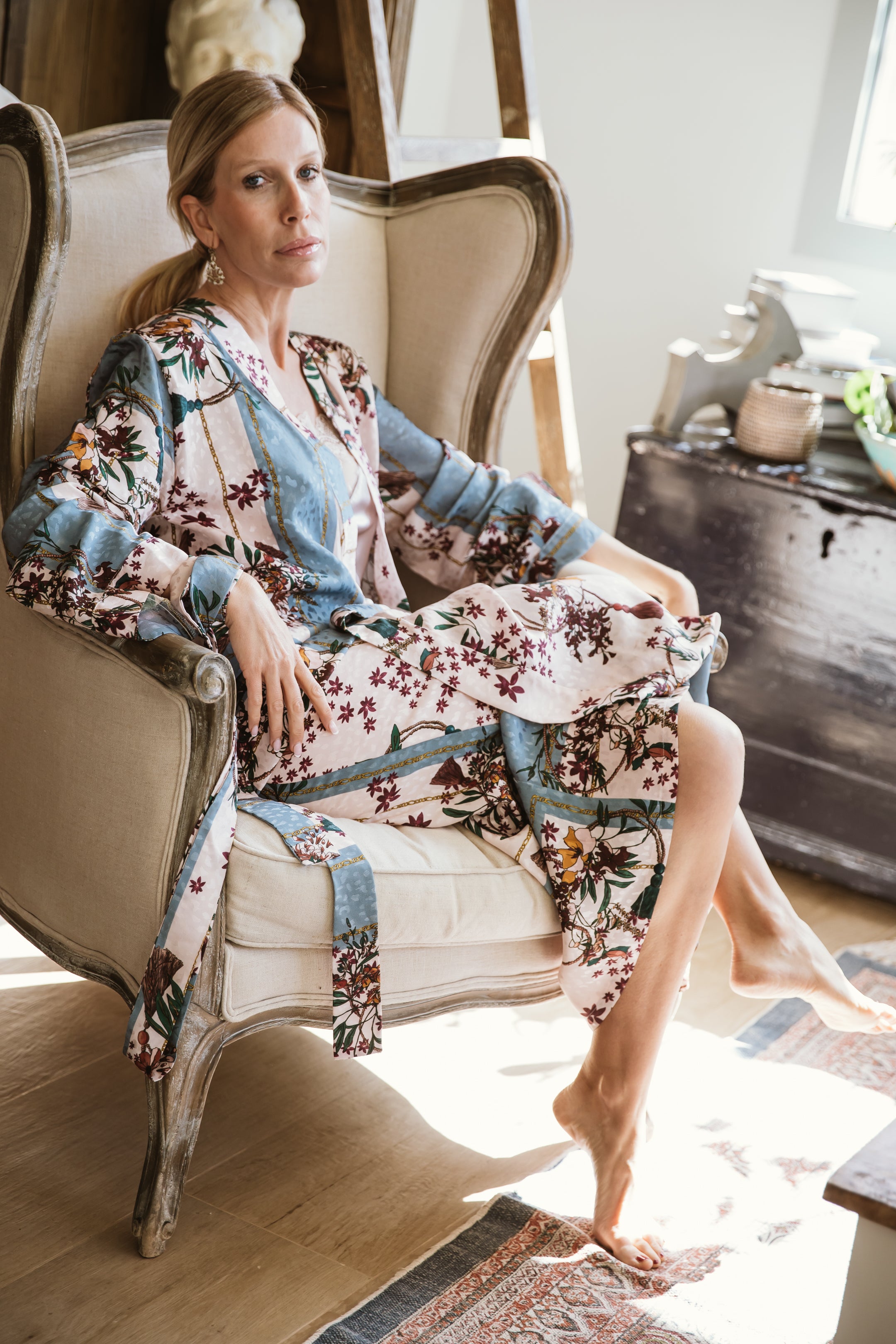 "A stunning floral kimono graced with a garden of intricate blossoms. The vibrant and detailed floral patterns cascade across the fabric, creating a visually enchanting ensemble. With a graceful drape and an airy feel, this kimono captures the essence of elegance and nature, making it a striking choice for a range of stylish looks."