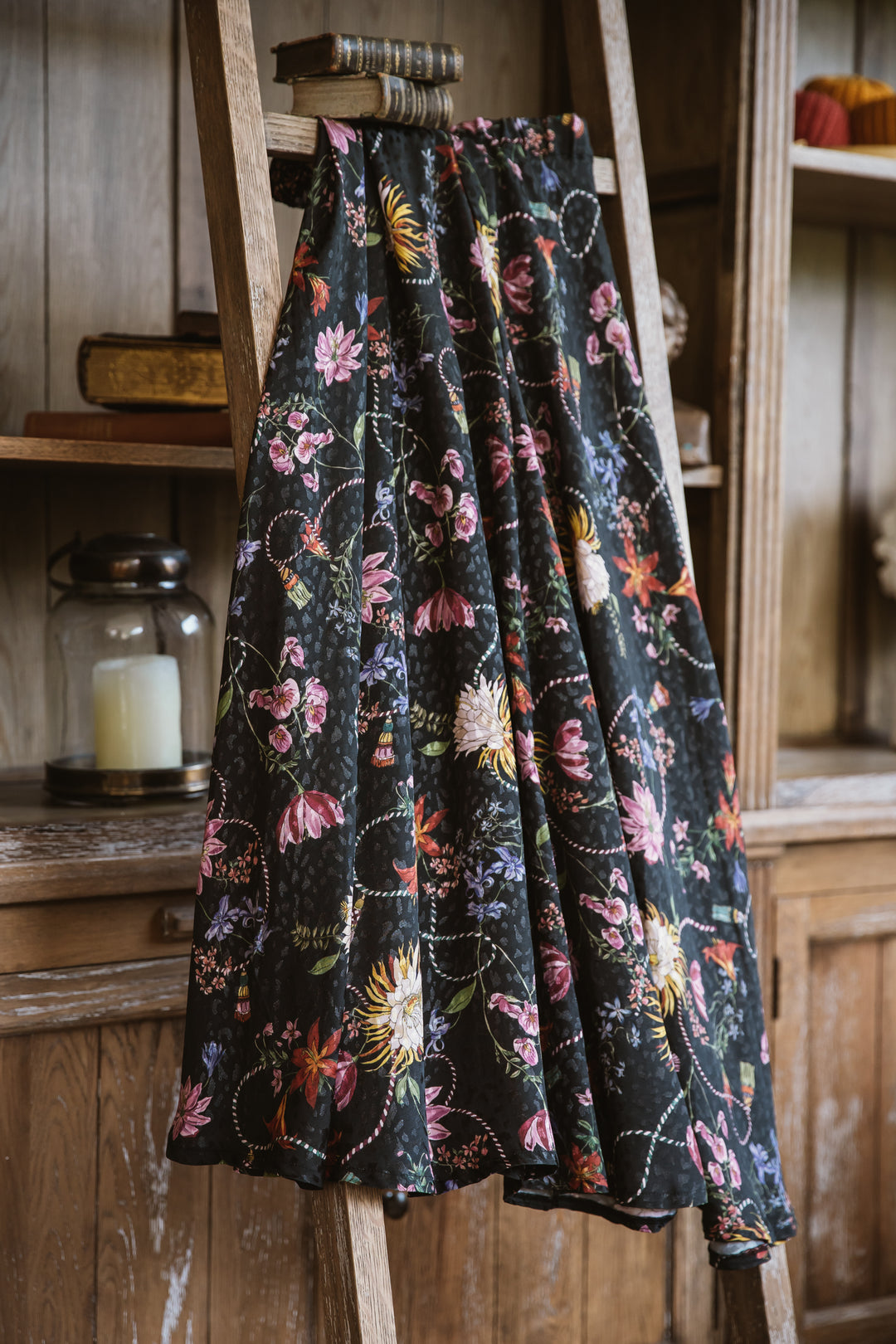  "An elegant floral jacquard skirt featuring a textured pattern of intricate flowers in soft pastel hues. The A-line silhouette and knee-length design create a graceful and feminine look, perfect for both formal and casual occasions."