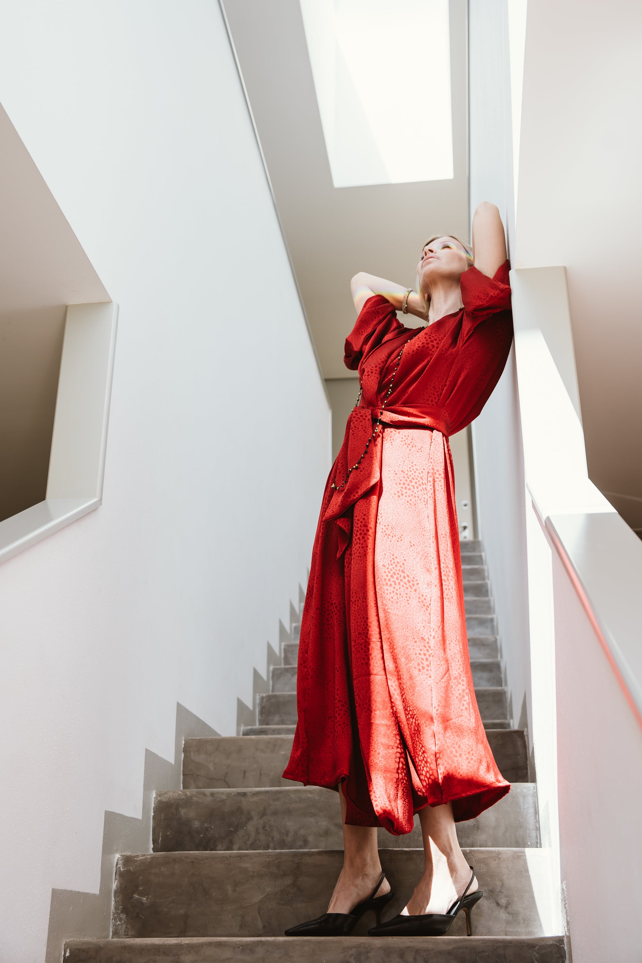 "A striking red spotted jacquard kimono, adorned with bold and intricate patterns. The deep red color commands attention, while the spotted jacquard design adds a layer of texture and visual interest. This kimono effortlessly combines a vibrant hue with captivating detailing, making it a statement piece that adds flair and personality to any outfit."